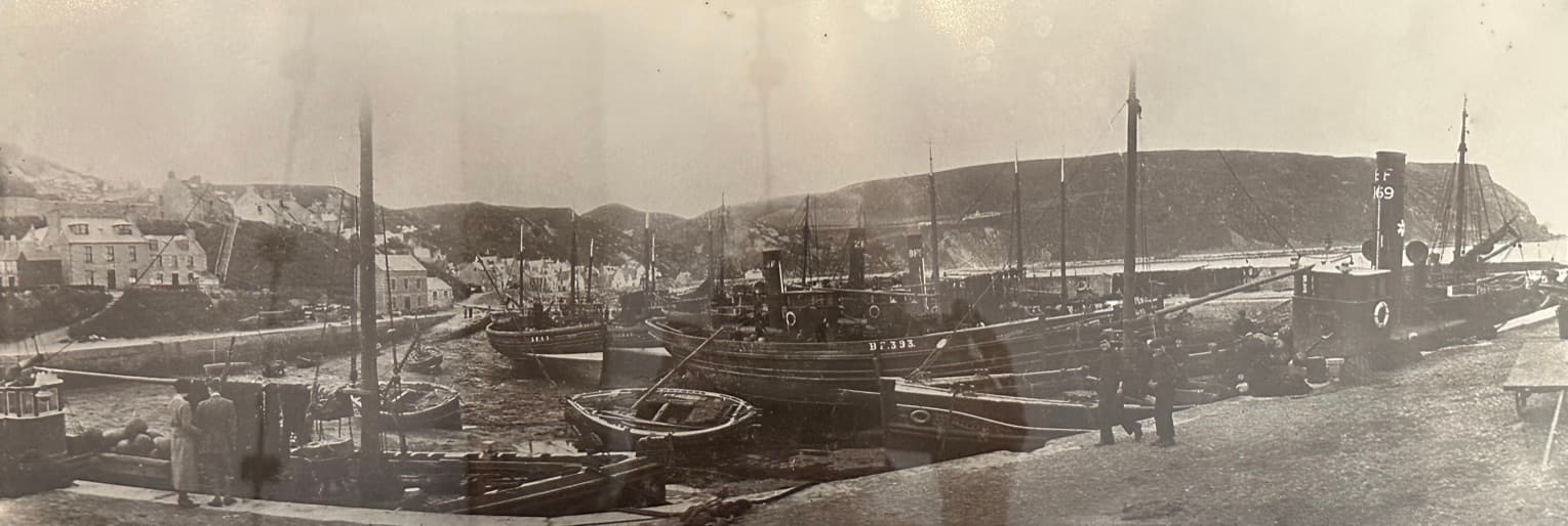 Panoramic view of steam drifters crowding the harbour, historic photo