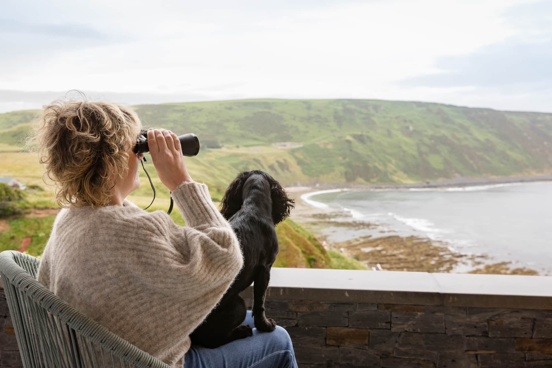 Watching the coast through binoculars with the resident dog