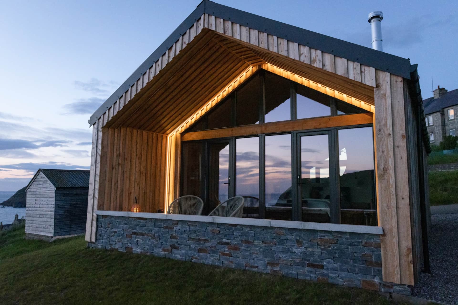 Muckle View glowing at dusk with the gable window lit