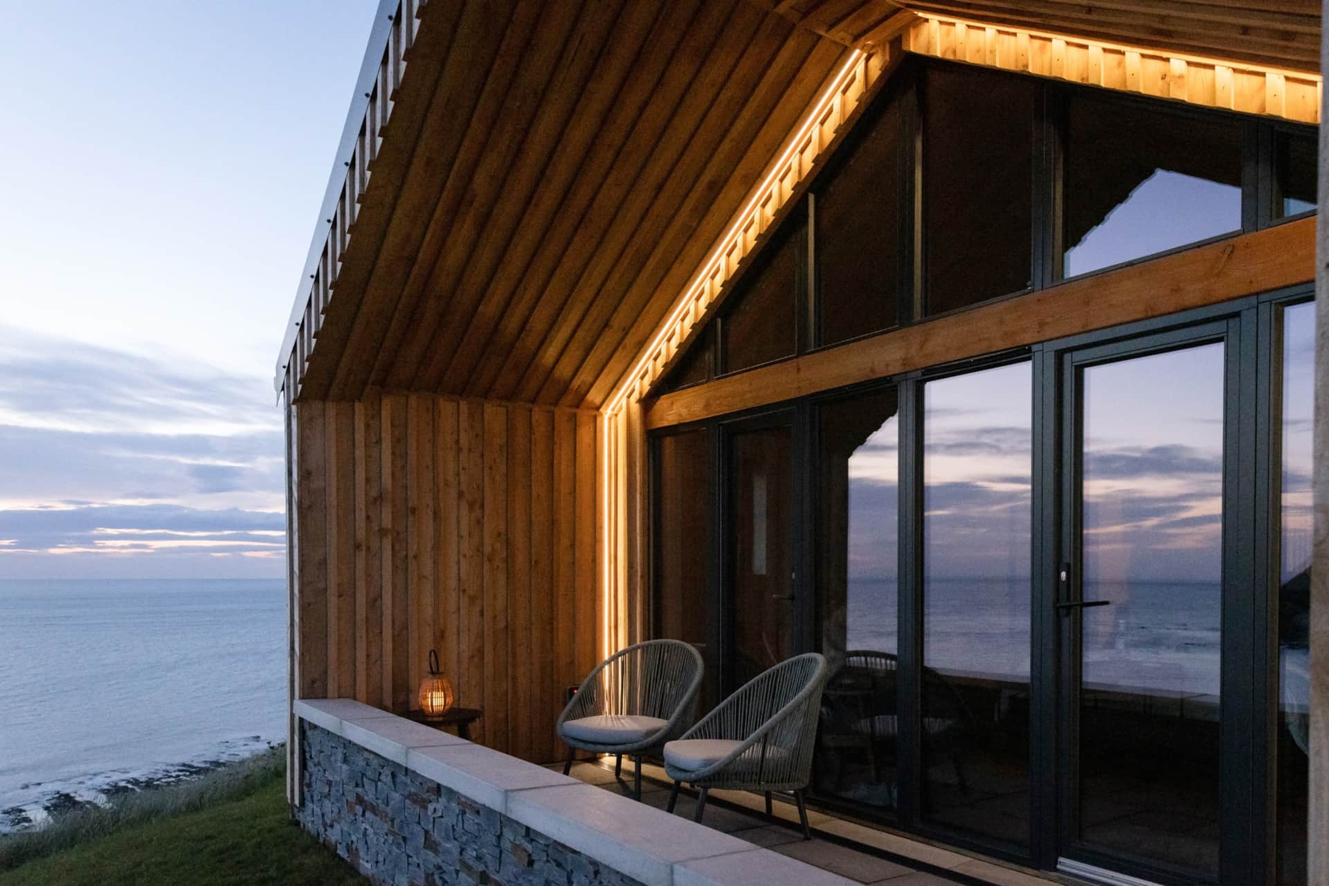 Twilight view across the terrace seating to the sea