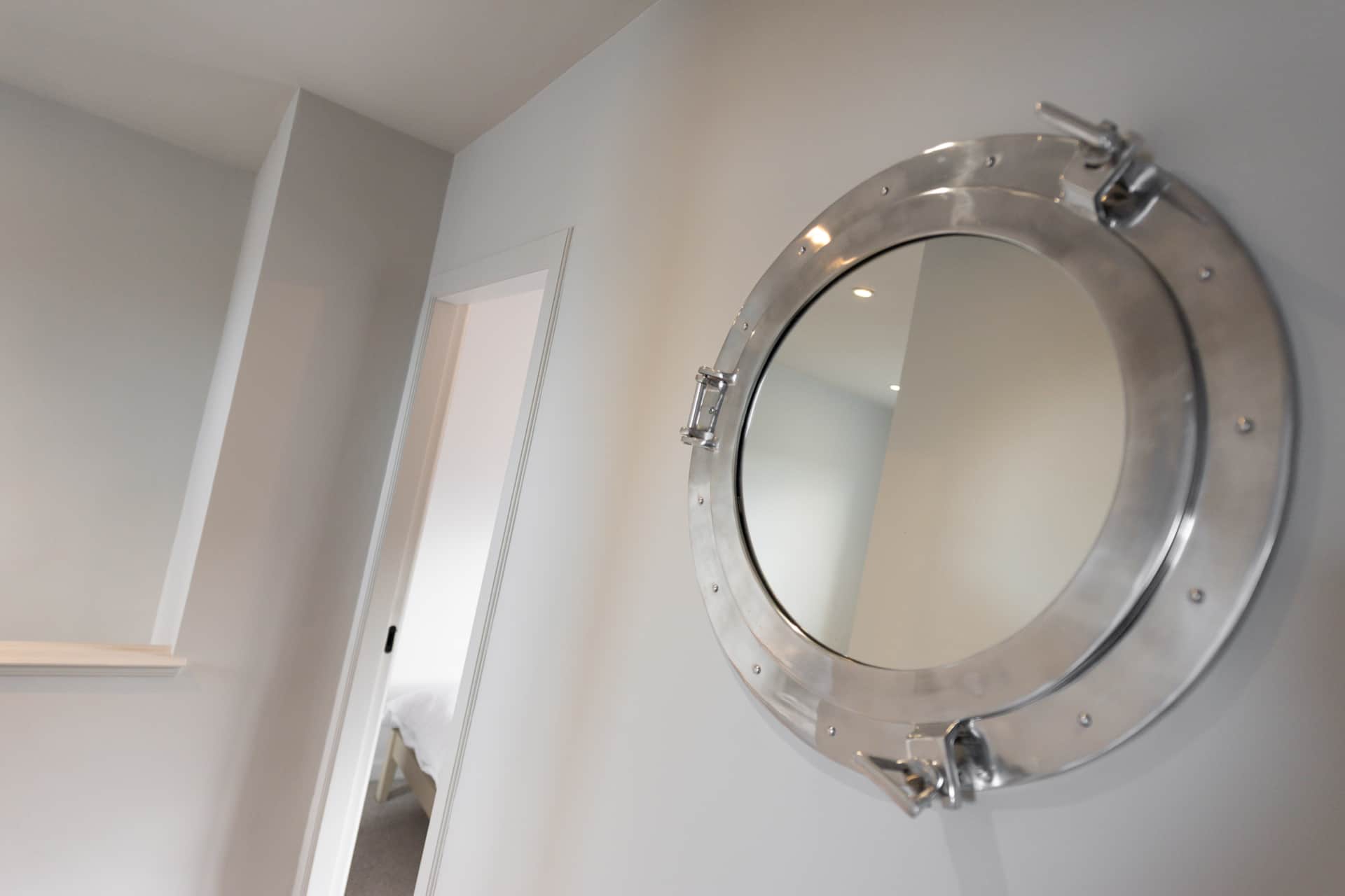 Porthole mirror in the upstairs hallway