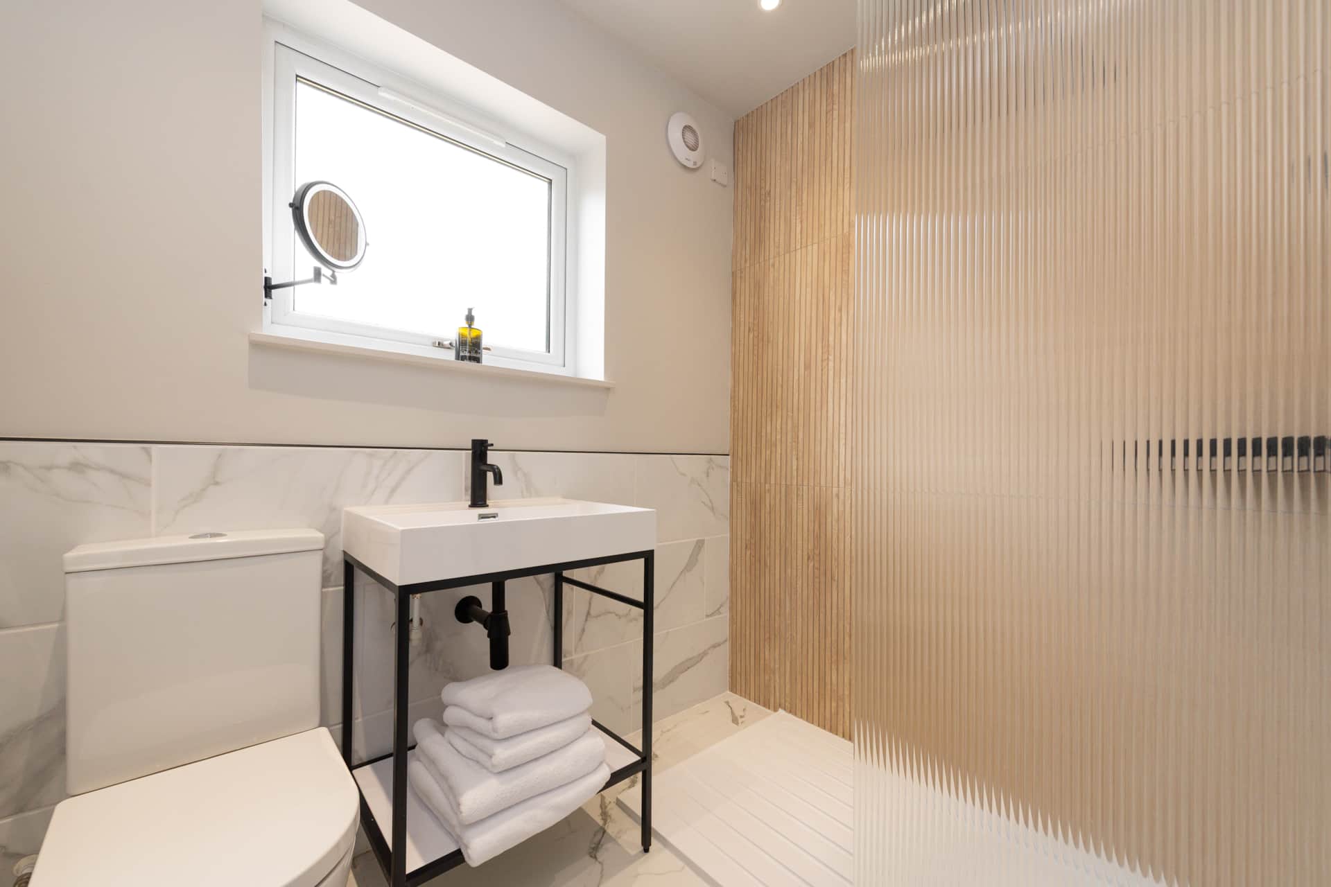 Bathroom with walk-in shower and marble tile