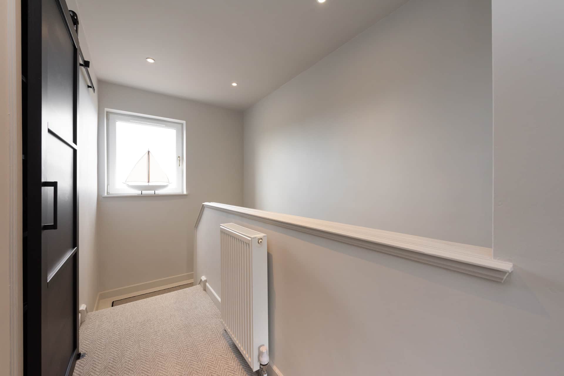 Upstairs landing with a sliding barn door